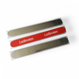 Three emery nail files in transparent packaging, featuring a shiny silver side and one red file with branding.