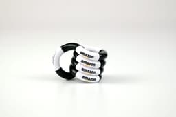 A set of four black and white Tangle toys featuring branding on each piece.