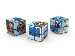 A trio of 2x2 Rubik's Cubes featuring vibrant blue and black designs, each with unique images and branding.