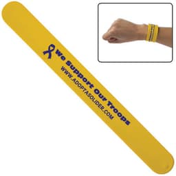 A yellow silicone snap wristband featuring a logo and text supporting troops.