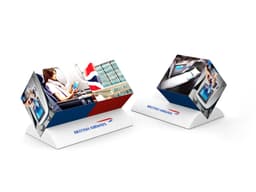 Two triangular promotional stands in red, white, and blue featuring images related to air travel, with branding present.