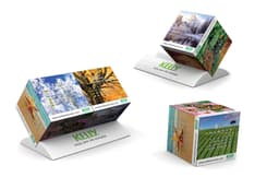 A promotional calendar featuring vibrant images and a stand, designed in multi-coloured graphics with a logo.