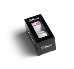 A black box containing two white golf balls, featuring a logo and red accents.