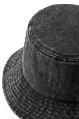 A dark grey, 280gsm 100% cotton drill washed bucket hat with a textured finish and stitched detailing.