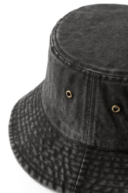 A dark grey bucket hat made from 100% cotton drill, featuring eyelets and a textured surface.