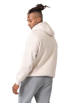 A light beige hooded sweatshirt featuring a kangaroo pocket, paired with grey pants. It has a logo on the garment.