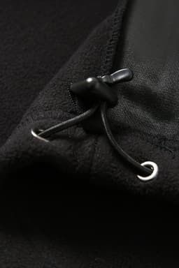 A close-up of a black polar fleece half zip top featuring a drawcord and toggle adjustment.
