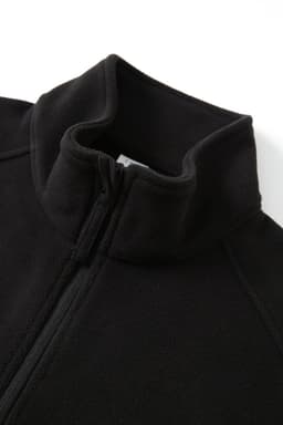A black polar fleece half zip top with a high collar and a zip closure. The material appears soft and warm.