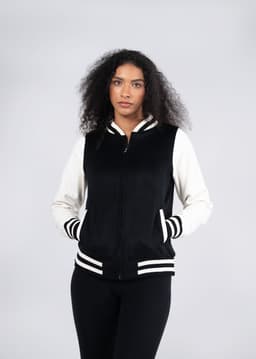 A black and white varsity jacket featuring a zip front and striped cuffs, designed for women and juniors.