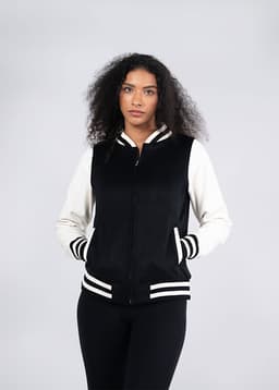 A black and cream varsity jacket with a zip front, striped cuffs, and side pockets. It features a branding logo.
