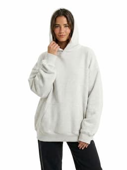 A grey oversize hoodie with a hood and front pocket, worn by a model against a white background.