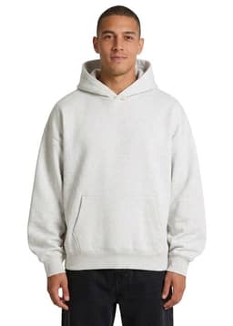 An oversized hoodie in a soft cream colour, featuring a front pocket and a hood. There is a logo on the garment.