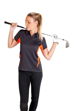 A woman in a grey polo shirt with orange accents holds a golf club, standing in a relaxed pose.
