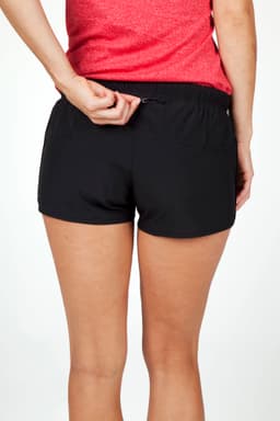Women's FLEX shorts in black, featuring a stretchy fabric and an elastic waistband. Branding is visible on the shorts.