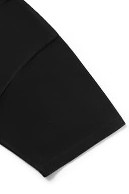 A black oversized T-shirt made from 230gsm 100% organic cotton, featuring a logo on the fabric.