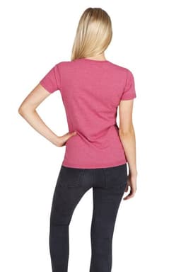 A woman wearing a pink marl T-shirt, viewed from the back, paired with dark jeans. The shirt has a logo.