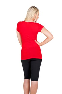 A red women's V-neck T-shirt viewed from the back, paired with black leggings. The shirt features a logo.
