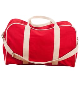 A red cotton canvas sports bag with cream straps and a detachable shoulder strap. It features a logo.