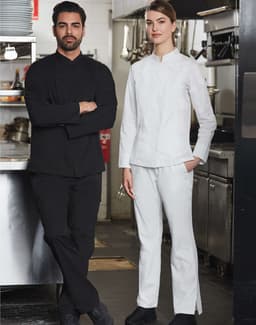 A black men's chef jacket and a white women's chef jacket are displayed on models in a kitchen setting.