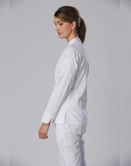 A white chef jacket designed for women, featuring long sleeves and a simple, elegant design.
