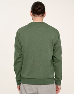A unisex crew neck sweater in a rich green colour, viewed from the back. It features a logo on the fabric.