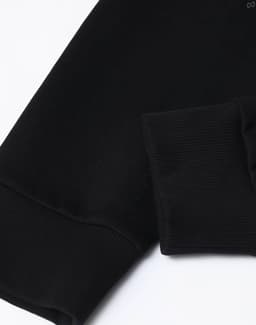 A black unisex crew neck sweater featuring airlayered CVC fabric with ribbed cuffs. It has a logo on the design.