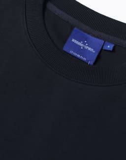 A dark navy unisex crew neck sweater with ribbed detailing and a branded label inside the collar.