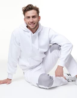 A white fleecy hoodie with a front pocket, featuring a logo, worn with matching light grey pants.