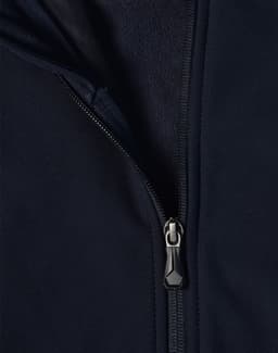 A navy softshell high-tech jacket featuring a zippered front and a fleece lining. The jacket includes a logo.
