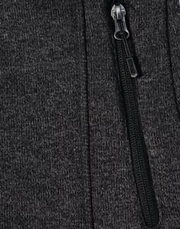A dark grey fleece jacket with a zippered front and soft texture, featuring a small logo on the fabric.