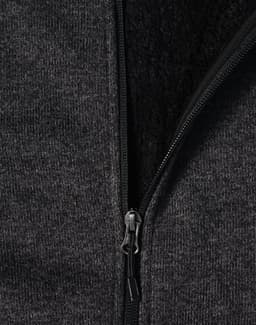 A ladies' grey bonded fleece jacket featuring a zip closure and soft inner lining. It includes a logo on the fabric.