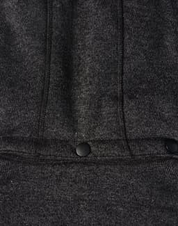 A black heather fleece jacket featuring a zip closure and two snap buttons at the hem. It has a logo present.