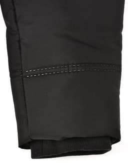 A close-up of a black sustainable parka jacket featuring a seamless design and detailed stitching at the cuff.