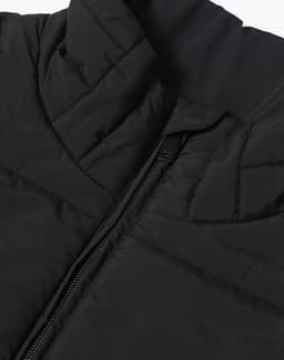 A black insulated puffer vest featuring a 3D cut and a zipper, with a branded logo.