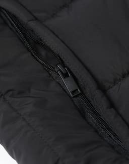 A close-up of a black insulated puffer vest featuring a zipper and quilted fabric texture.