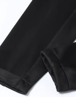 A black softshell corporate jacket with sleek, smooth fabric and finished sleeves. It features a logo on the fabric.