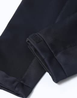 A close-up of the cuffs of a black ladies' sustainable softshell corporate jacket with a velcro detail.