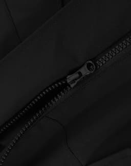 A black quilted waterproof jacket featuring a zipper detail. The fabric appears smooth and durable.