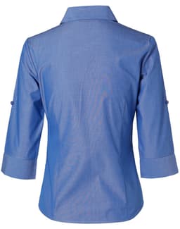 A blue women's button-up shirt with 3/4 sleeves, featuring a collar and rolled-up cuffs. The shirt has a logo.