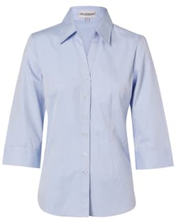 A light blue women's fine chambray shirt with 3/4 sleeves and a button-up front. Features a collar and a logo.