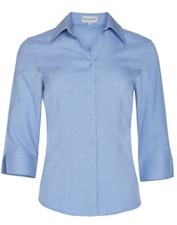 A light blue women's 3/4 sleeve shirt with a collared neckline and buttons, featuring a logo on the label.