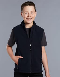 A boy wearing a navy blue fleece vest with a zip and side pockets, smiling against a grey background.