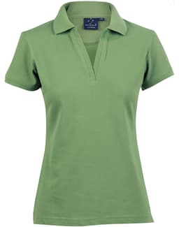 A green ladies’ polo shirt with a collar and a logo on the upper left side.