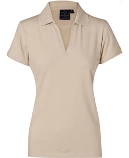 A beige ladies' polo shirt featuring a collar and a logo. Ideal for casual or sporty wear.