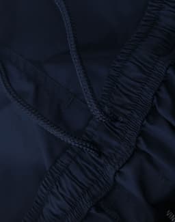 Navy unisex mercerised cotton shorts featuring an elastic waistband with a drawstring. Includes a logo detail.