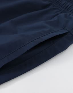 Navy unisex mercerised cotton shorts with an elastic waistband and side pockets. Features a branding logo.