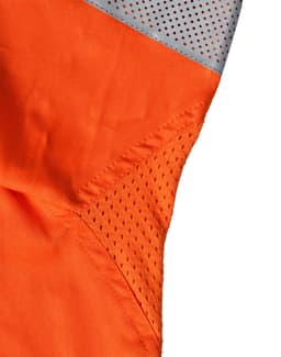 An orange work shirt featuring grey mesh panels, designed for safety in a work environment.