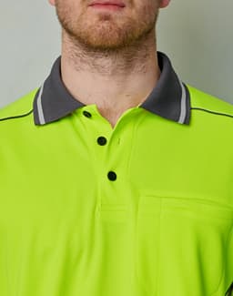 A hi-vis lime green polo shirt with a grey collar and a pocket, featuring a logo on the chest area.