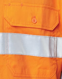An orange safety shirt featuring a reflective silver tape and a pocket with an orange button.