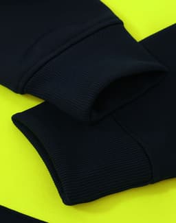 A close-up of a black fleece hoodie with bright yellow accents, featuring ribbed cuffs and a logo.